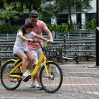 Dad and girl riding bike